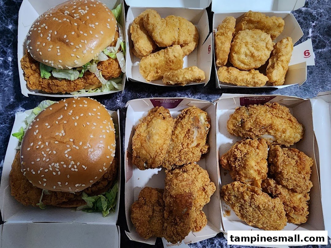 An assortment of McDonald's fried chicken, including burgers, nuggets, and chicken pieces.