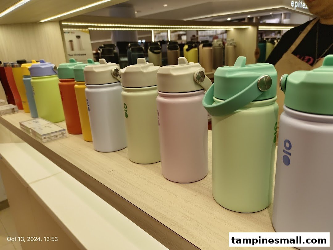 A vibrant display of colorful Montigo water bottles on a wooden shelf.