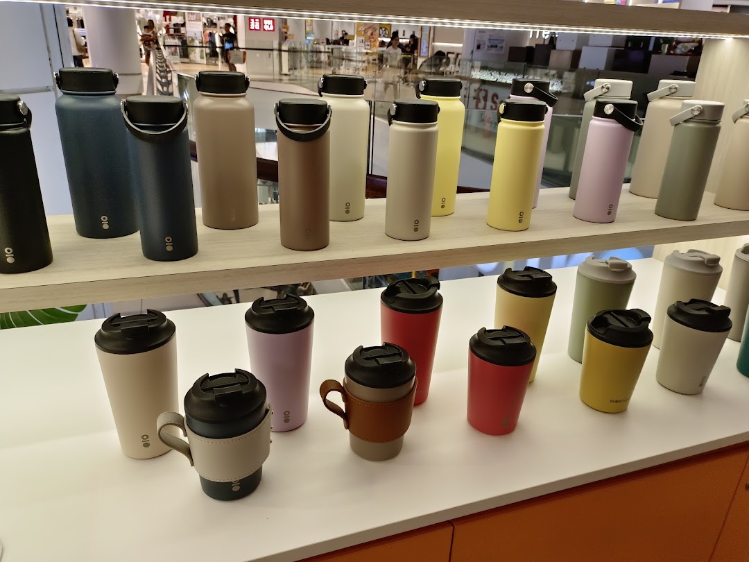 A vibrant display of various colored water bottles and tumblers on shelves inside a retail store.