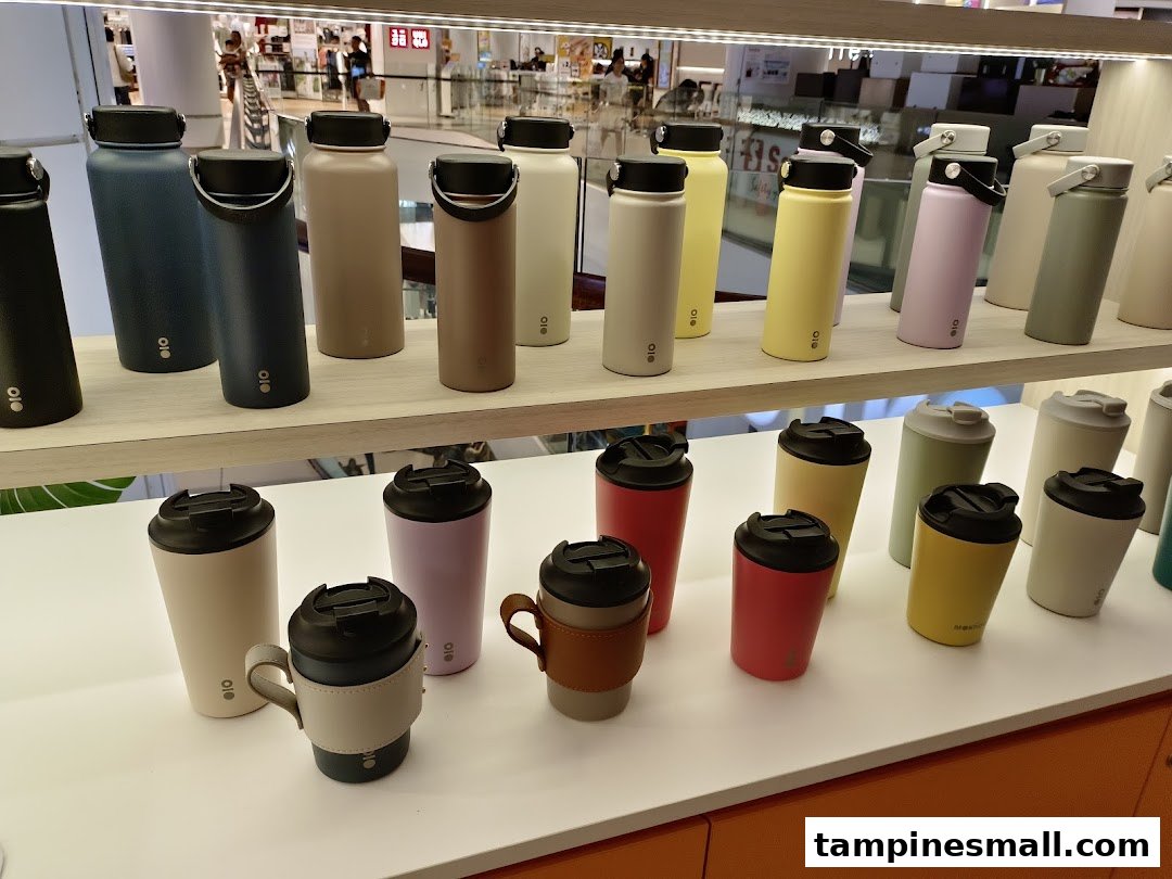 A vibrant display of various colored water bottles and tumblers on shelves inside a retail store.
