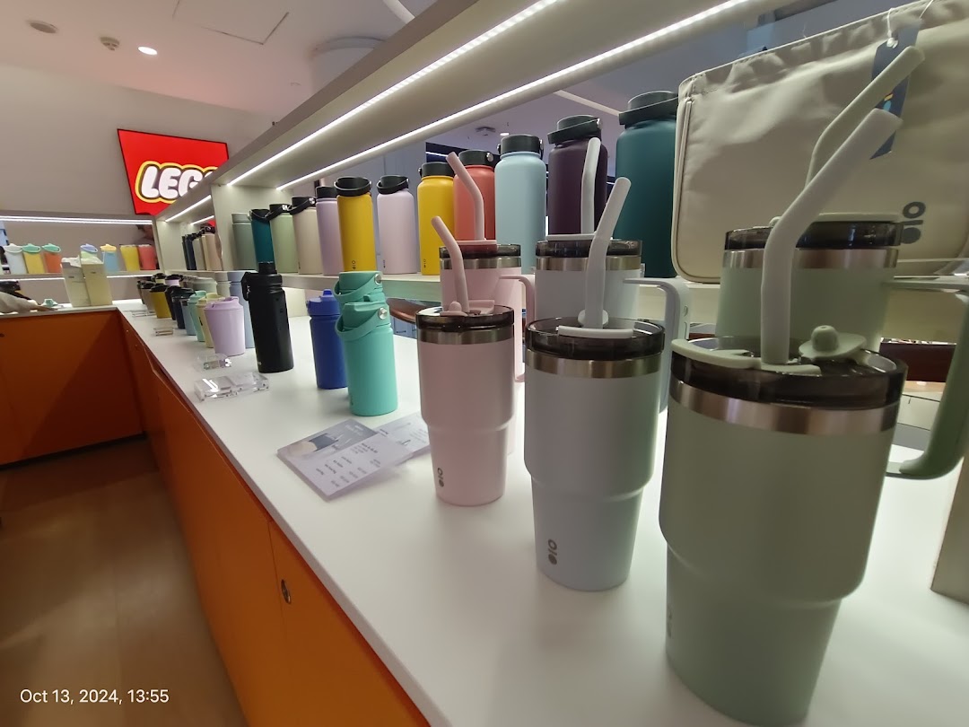 A vibrant display of colorful tumblers, water bottles, and hydration accessories inside a retail store.
