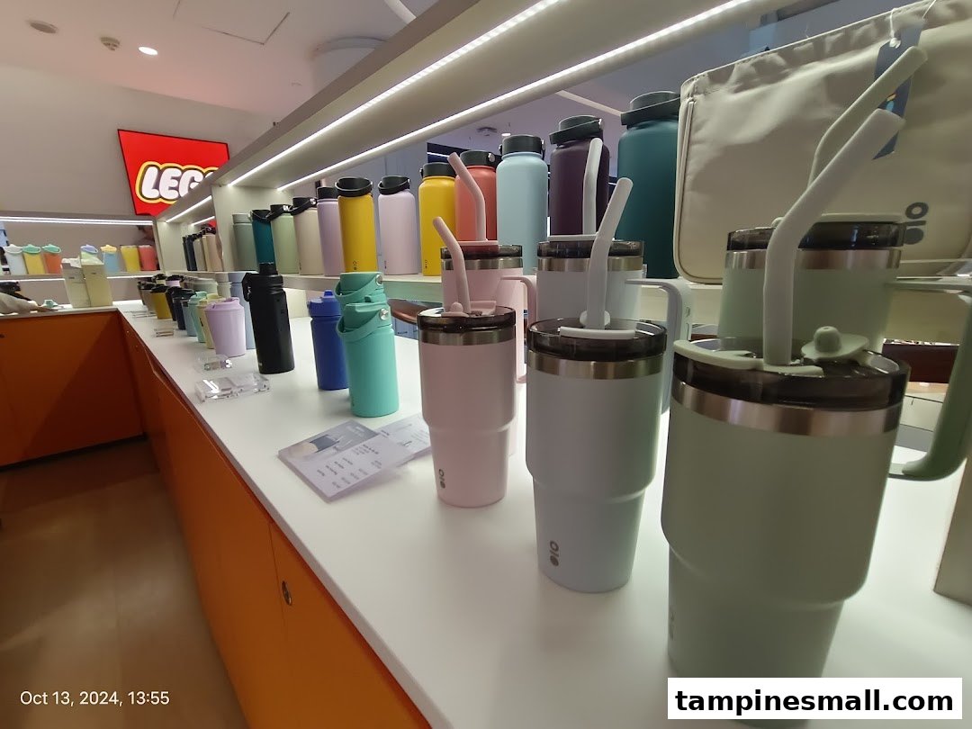 A vibrant display of colorful tumblers, water bottles, and hydration accessories inside a retail store.