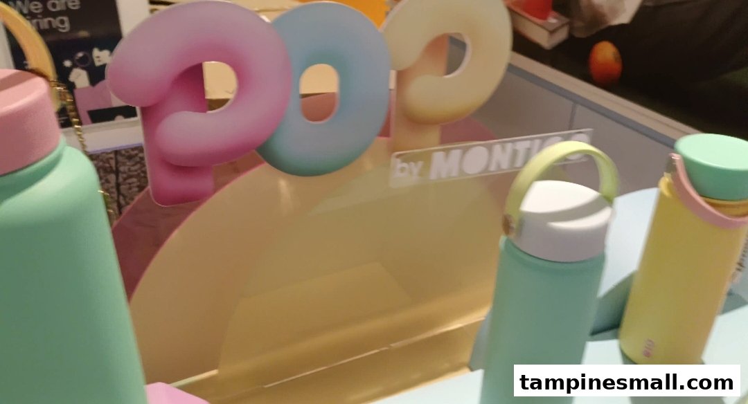 Colorful Montigo water bottles on display with a 'POO by MONTIGO' sign.