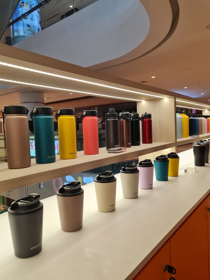 A vibrant display of Montigo water bottles and tumblers in various colors and sizes on shelves.