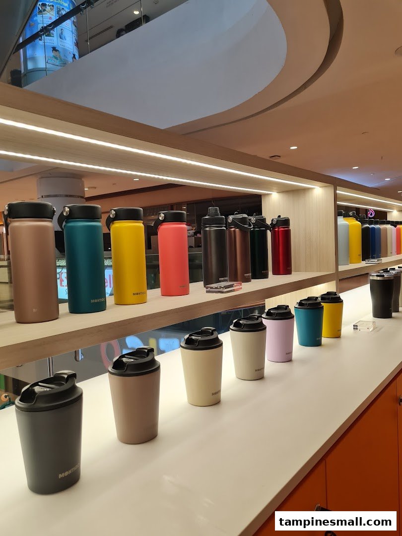 A vibrant display of Montigo water bottles and tumblers in various colors and sizes on shelves.