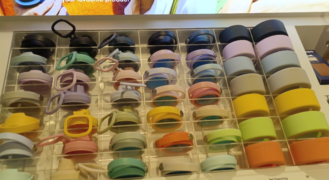 A vibrant display of colorful bottle accessories and lids, showcasing Montigo's diverse product range.