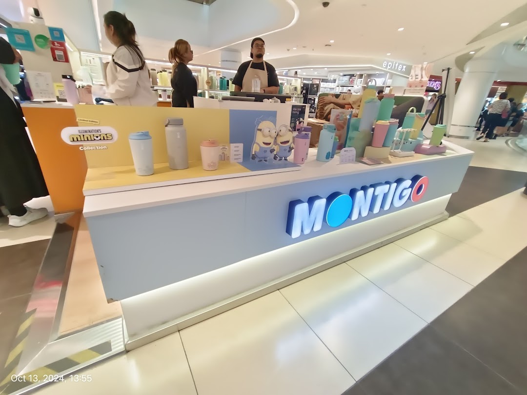 A vibrant Montigo display showcasing stylish hydration bottles and tumblers, including a Minions collection, within a mall setting.