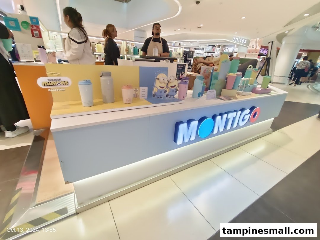 A vibrant Montigo display showcasing stylish hydration bottles and tumblers, including a Minions collection, within a mall setting.