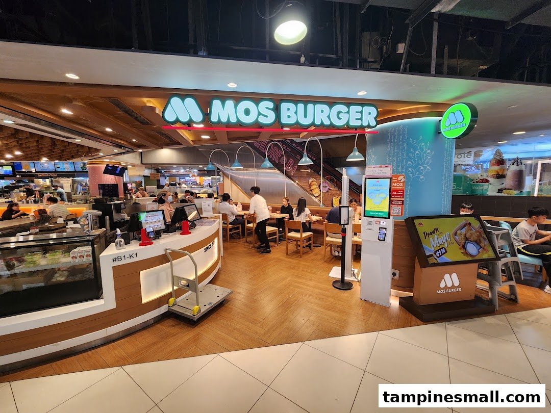 An inviting interior view of MOS Burger, showcasing its counter, seating area, and vibrant atmosphere.