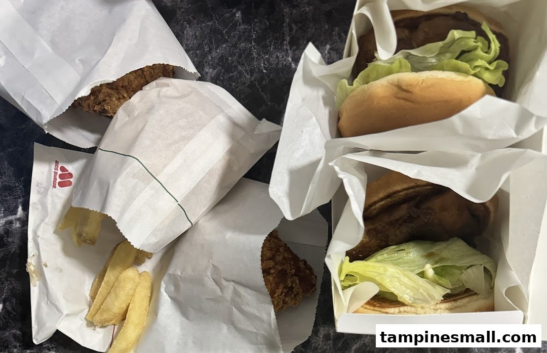 A top-down view of MOS Burger takeout, featuring burgers, fries, and fried chicken.