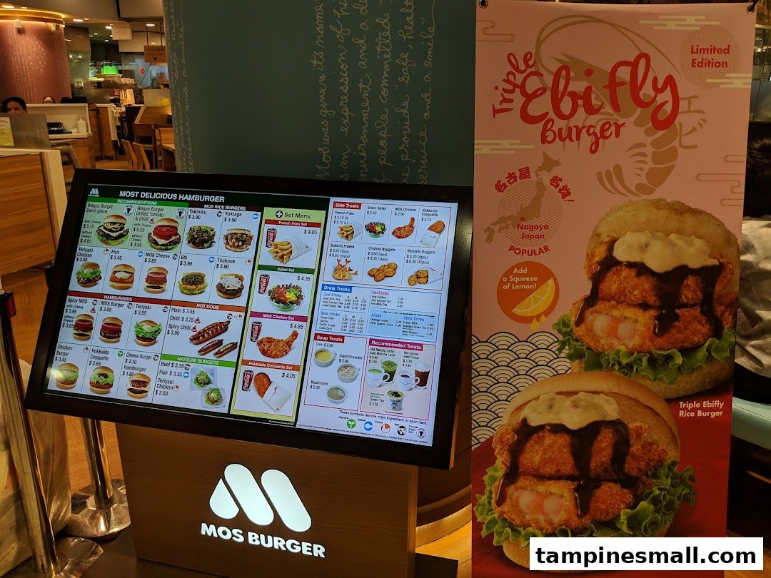 A digital menu board and promotional banner for MOS Burger, featuring various burgers and sides.