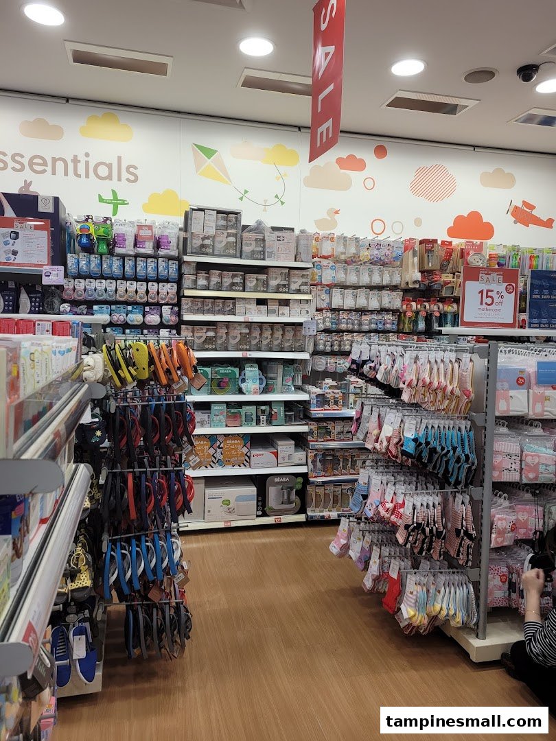 An aisle inside Mothercare, showcasing a wide range of baby essentials, feeding products, and infant clothing.