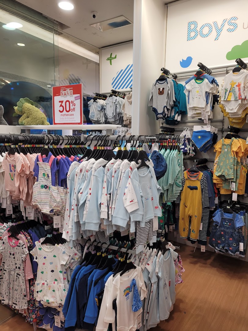 An interior view of Mothercare showcasing a wide array of colorful baby and kids' clothing on display, with a 30% off sale sign.