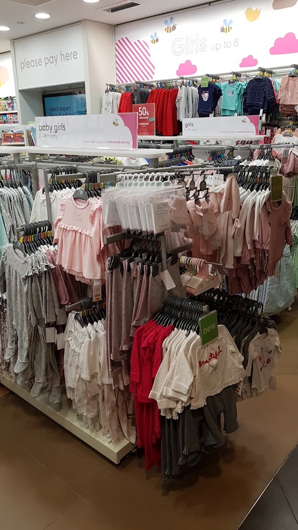 An interior view of Mothercare, showcasing racks of baby and girls' clothing and accessories.