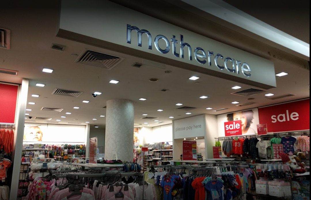 Interior view of Mothercare, showcasing baby and children's apparel, accessories, and prominent 'sale' signage.