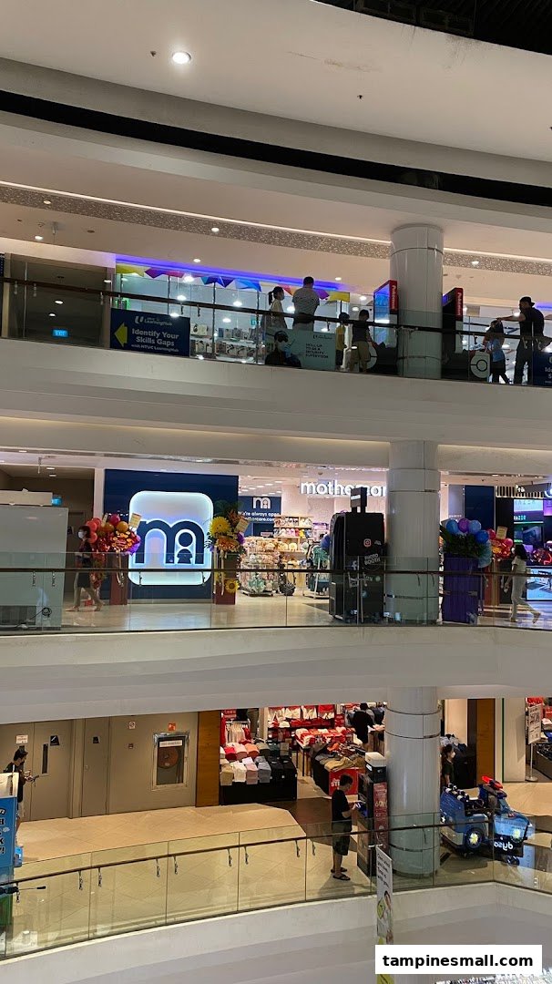 An interior view of a multi-level shopping mall, featuring the Mothercare store on an upper floor.
