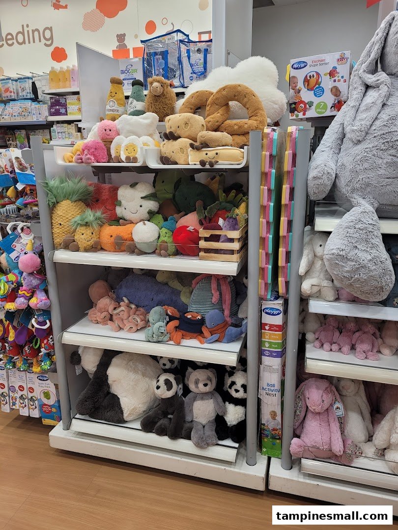A vibrant display of diverse plush toys, including food-themed and animal characters, on shelves inside Mothercare.