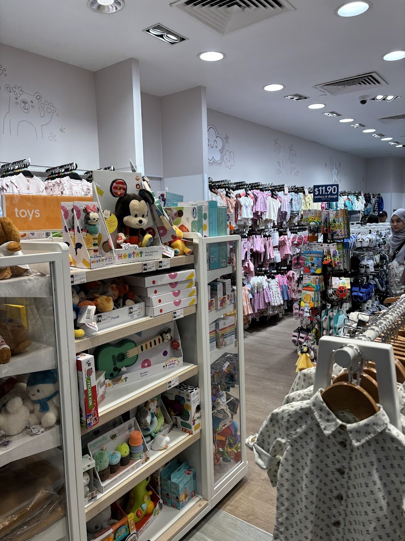 An interior view of Mothercare, showcasing a wide range of baby clothes, toys, and essential products.