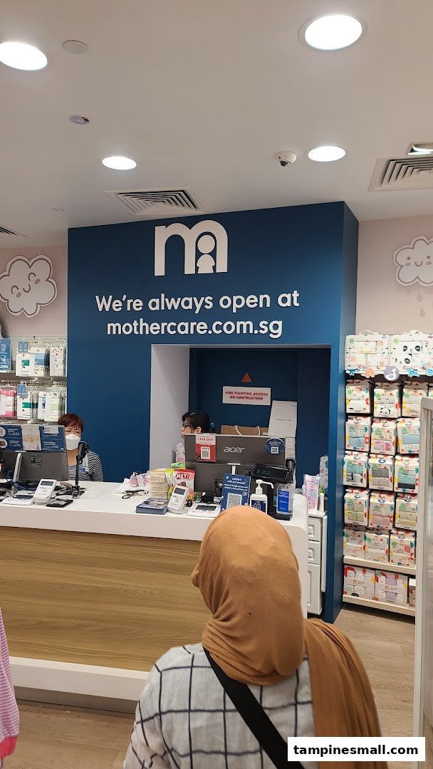 The Mothercare checkout counter with staff and baby products displayed in the background.