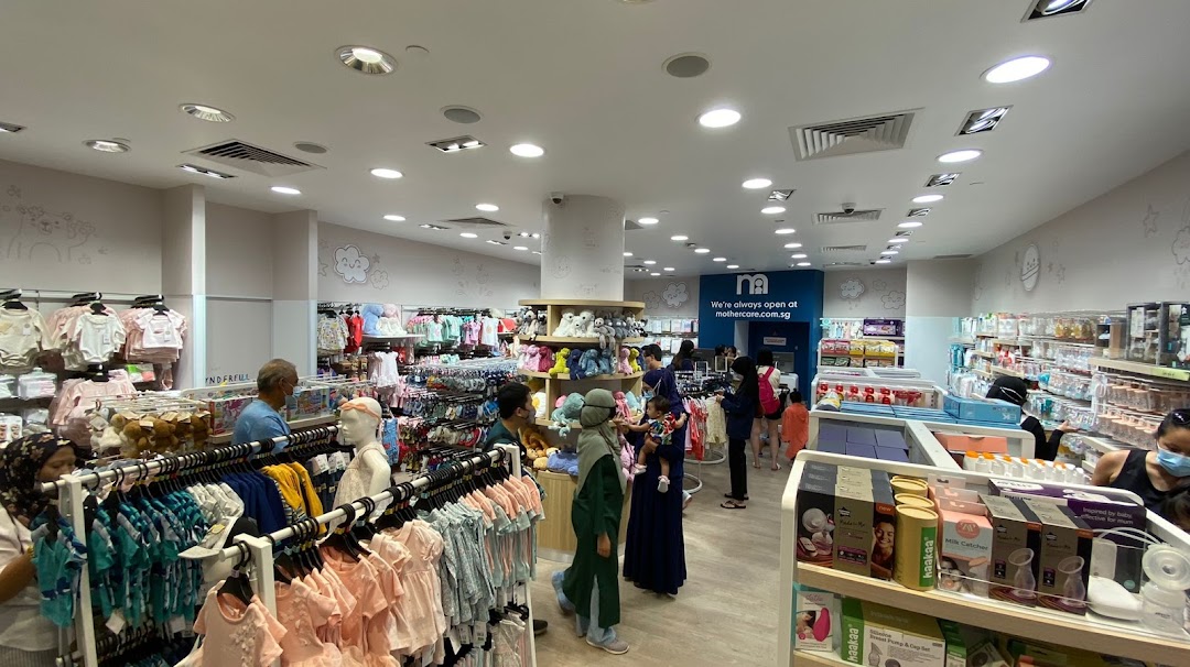 Interior view of Mothercare Tampines Mall with customers browsing baby clothes, toys, and essential products.