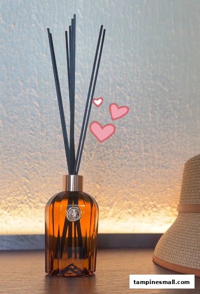 A stylish reed diffuser with black reeds in an amber glass bottle, displayed on a wooden surface.