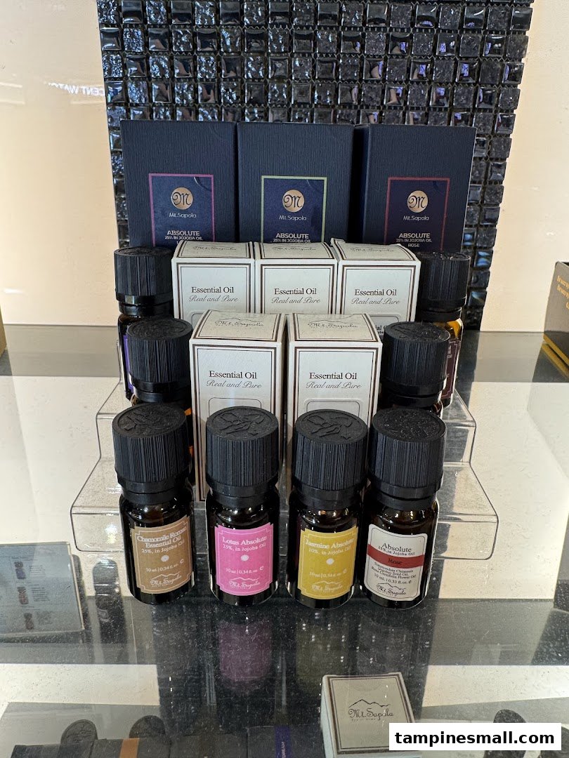 A display of Mt.Sapola essential oils and their packaging on a clear stand.