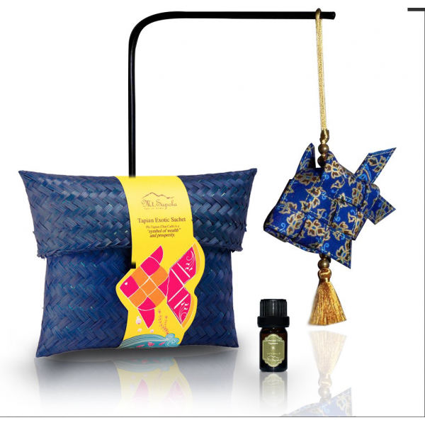A Mt.Sapola Tapian Exotic Sachet, decorative fish, and essential oil bottle on display.