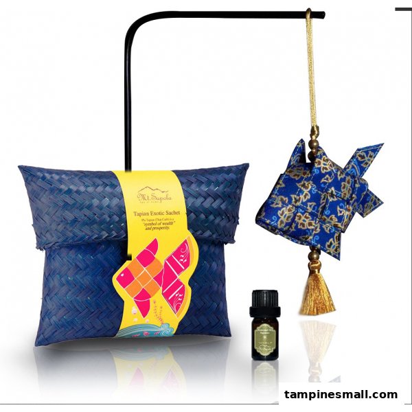 A Mt.Sapola Tapian Exotic Sachet, decorative fish, and essential oil bottle on display.