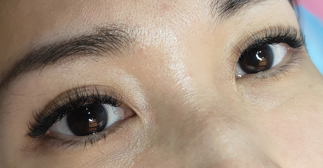 Close-up of a person's eyes featuring voluminous and perfectly applied eyelash extensions.