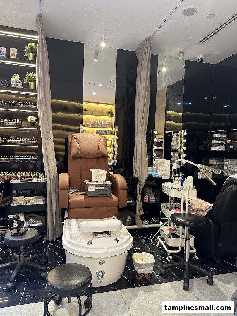 A comfortable brown massage chair and white foot spa basin at a modern nail salon.