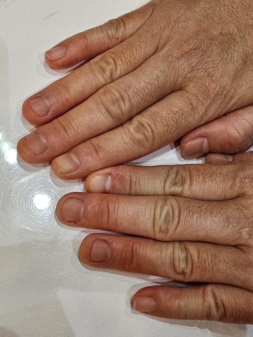 Close-up of hands, likely before a nail treatment, showing natural nails.