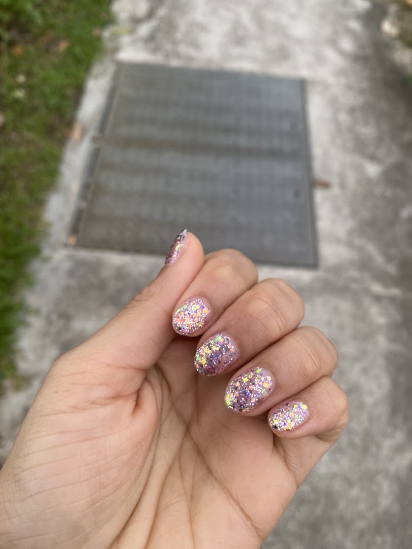 A hand showcasing sparkling glitter nail polish, likely a service from N20 Nail Spa.