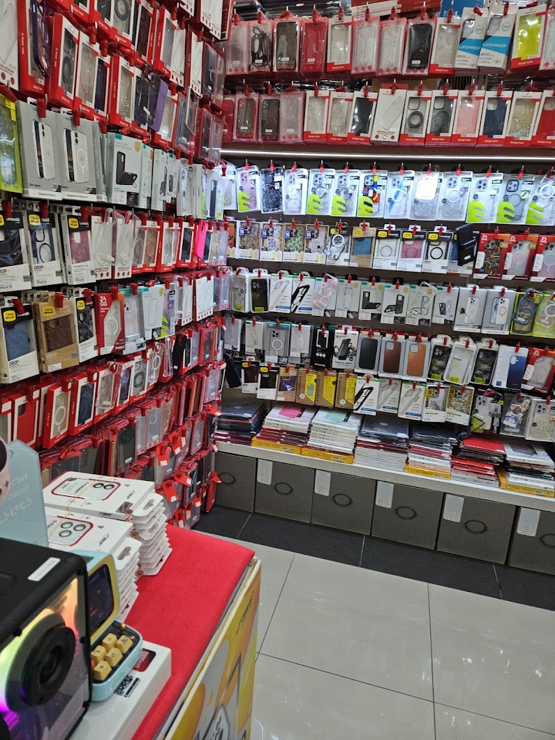 An interior view of a retail shop displaying a vast collection of phone cases and mobile accessories on wall racks.