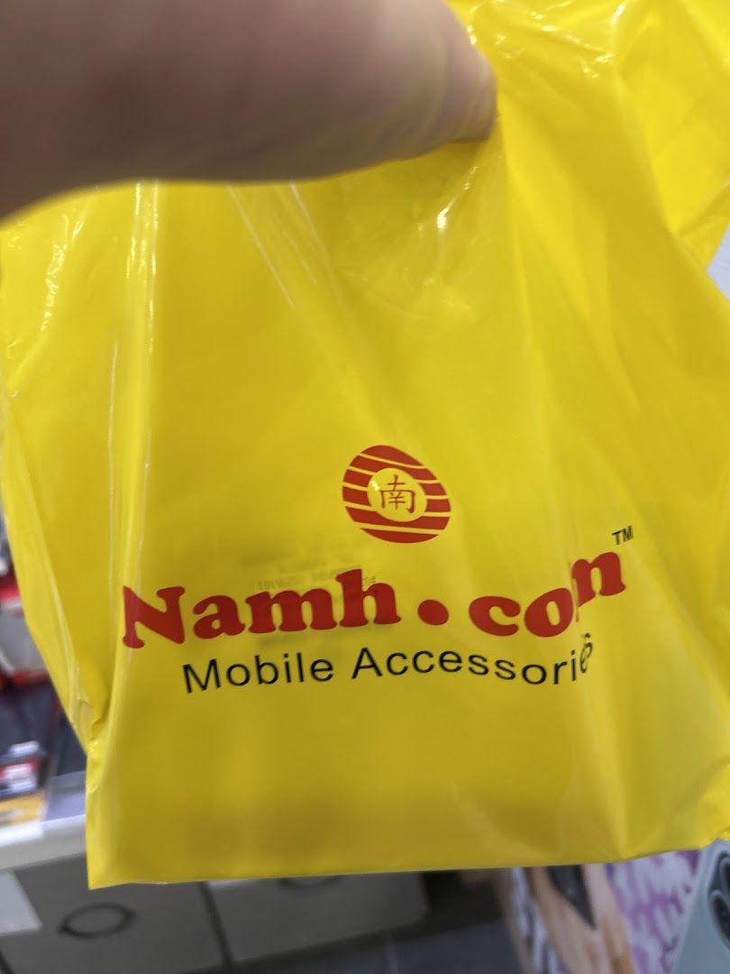 A person holds a bright yellow shopping bag featuring the 'Namh.com Mobile Accessories' logo.