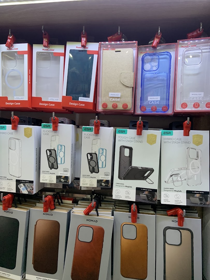 A retail display showcasing a wide variety of smartphone cases and accessories from brands like Namh.com, ESR, and Nomad.
