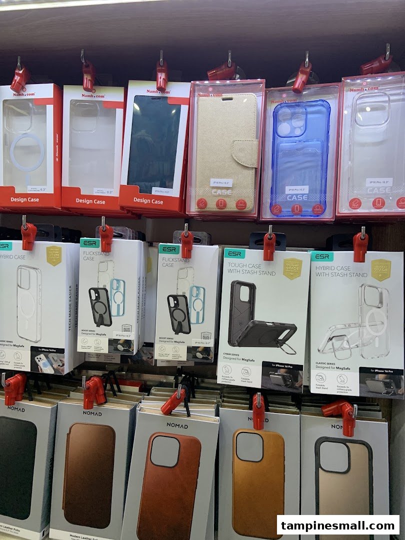 A retail display showcasing a wide variety of smartphone cases and accessories from brands like Namh.com, ESR, and Nomad.
