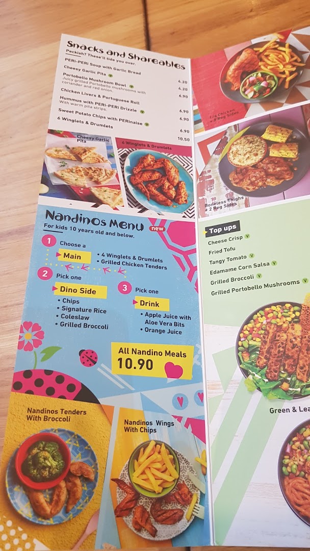 A detailed view of Nandos' menu, featuring snacks, shareables, and the kids' Nandinos menu.