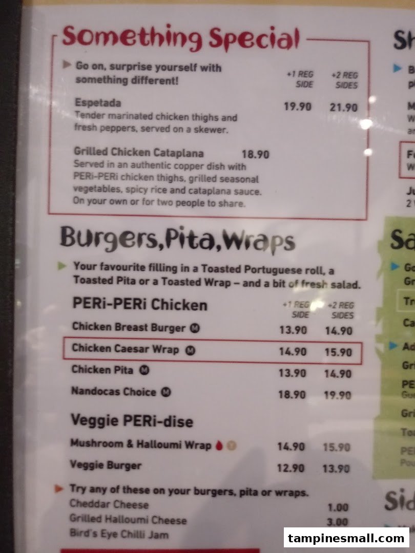 A close-up view of a Nando's menu displaying special dishes, burgers, pitas, wraps, and add-ons with prices.