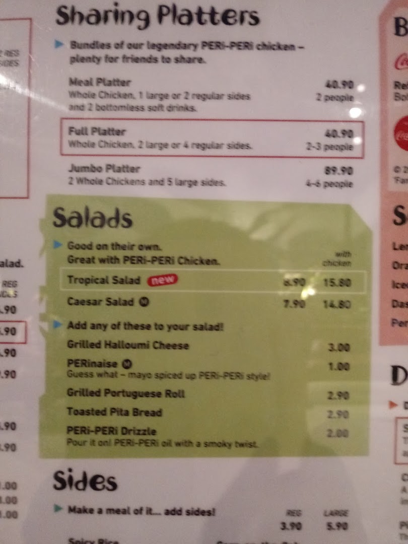 A close-up of the Nando's menu, featuring sharing platters, salads, and sides.