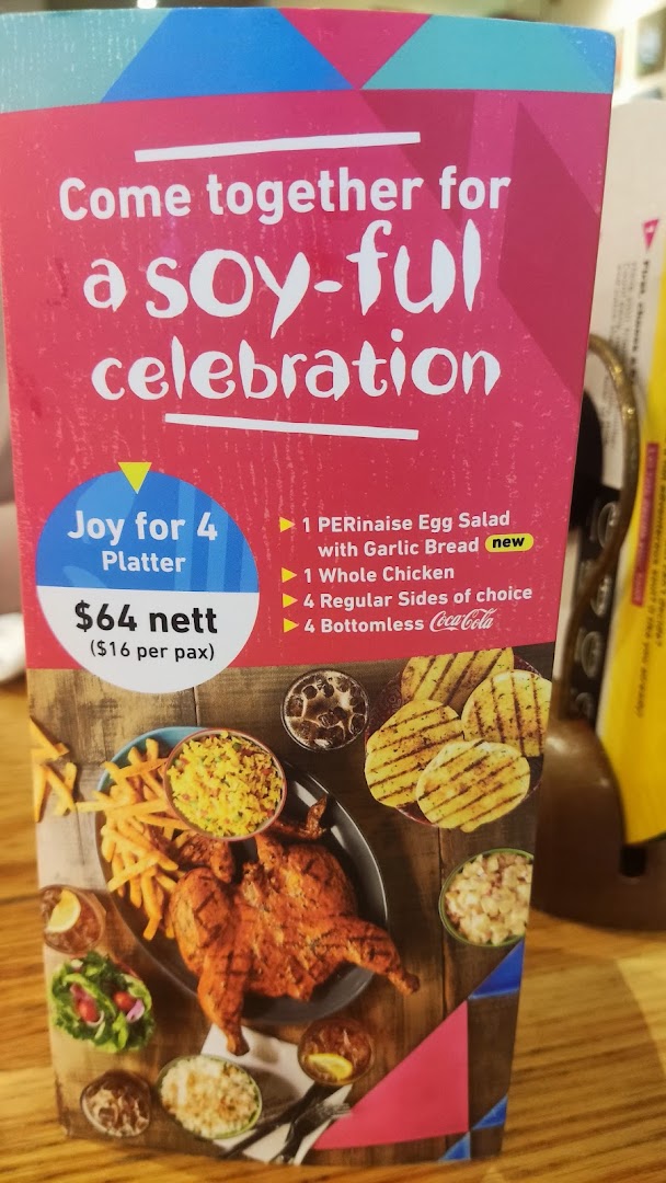 A Nando's menu display featuring the 'Joy for 4 Platter' with chicken, sides, and drinks.