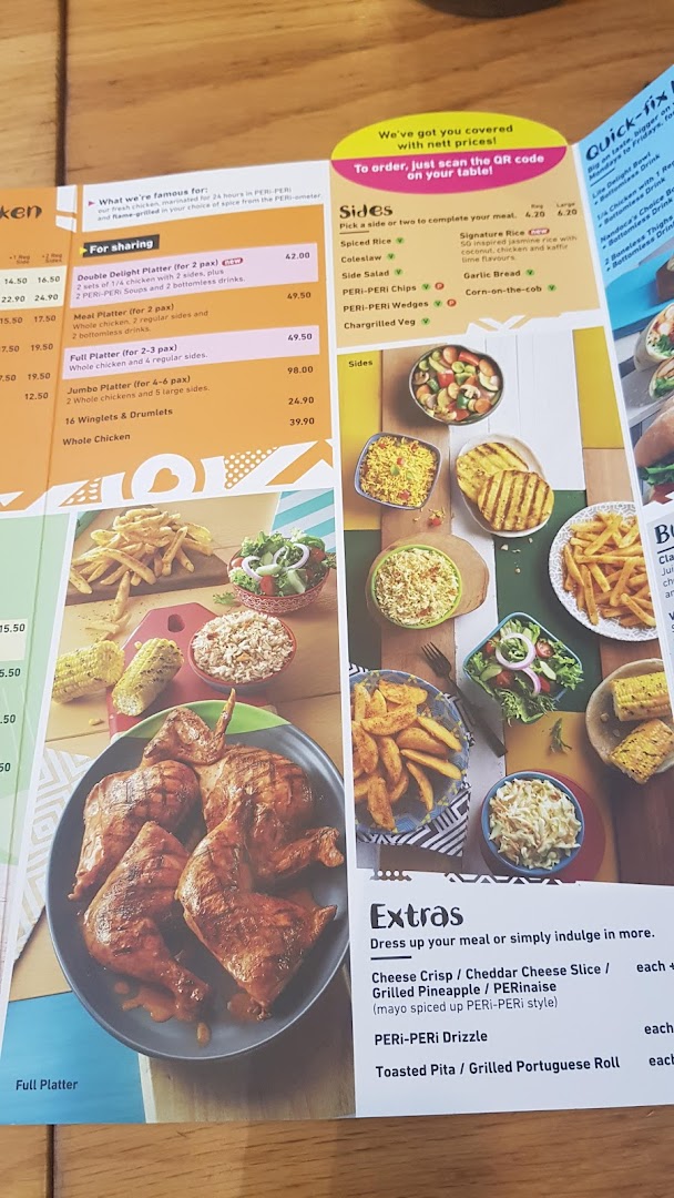 A close-up view of a Nandos menu, showcasing platters, sides, and extras with vibrant food photography.