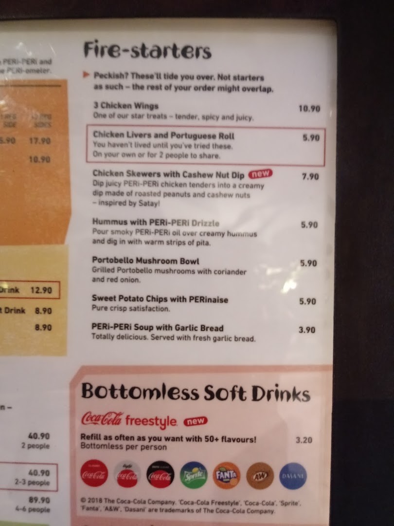 A detailed view of Nandos' 'Fire-starters' and 'Bottomless Soft Drinks' menu sections.