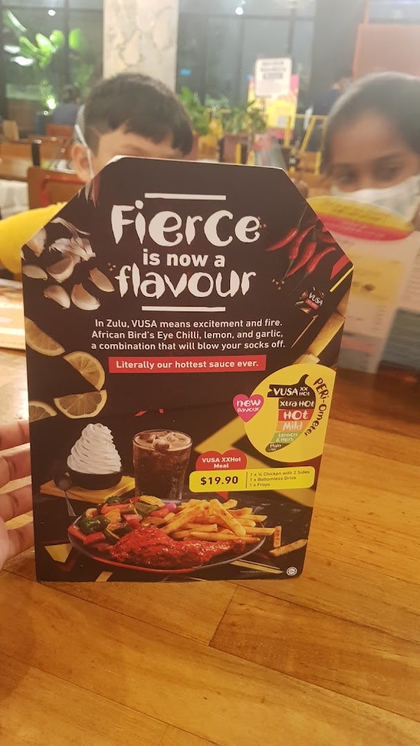 A Nando's promotional menu card showcasing the new 'VUSA XXHot' flavor and meal deal.