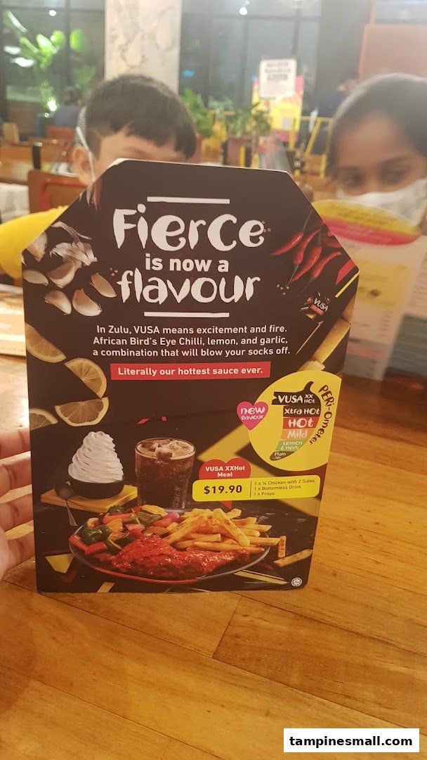 A Nando's promotional menu card showcasing the new 'VUSA XXHot' flavor and meal deal.