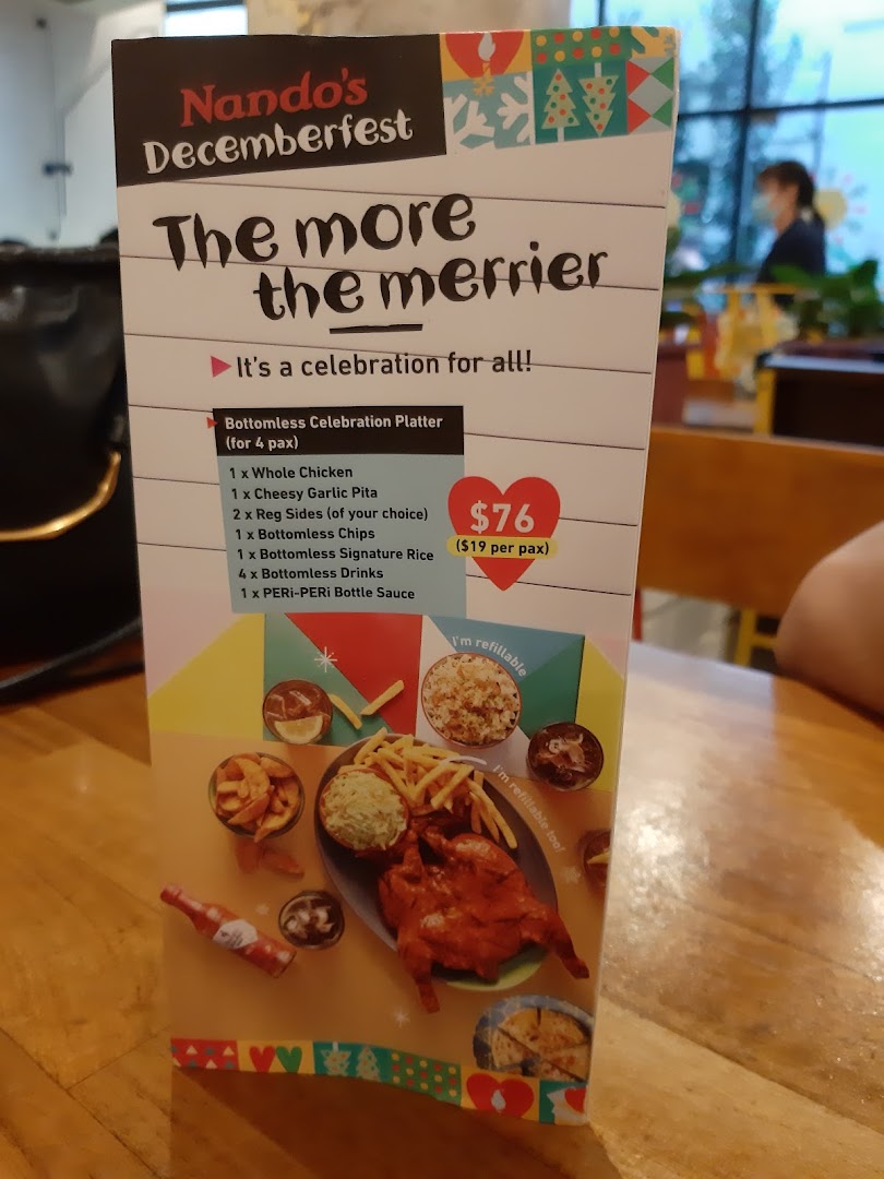 A Nando's Decemberfest menu displaying a 'Bottomless Celebration Platter' for four people.