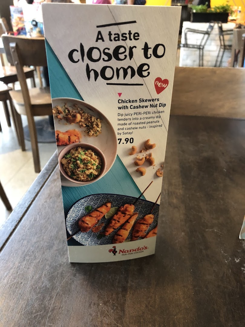 A Nando's table tent promoting new Chicken Skewers with Cashew Nut Dip.