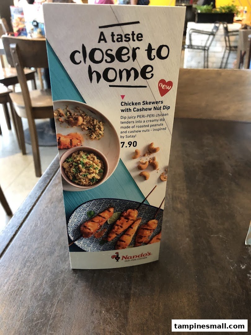A Nando's table tent promoting new Chicken Skewers with Cashew Nut Dip.