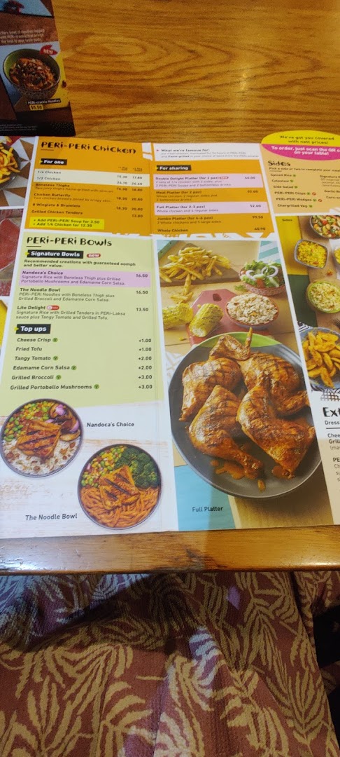 A detailed Nando's menu displaying PERi-PERi chicken, bowls, platters, and sides with prices.
