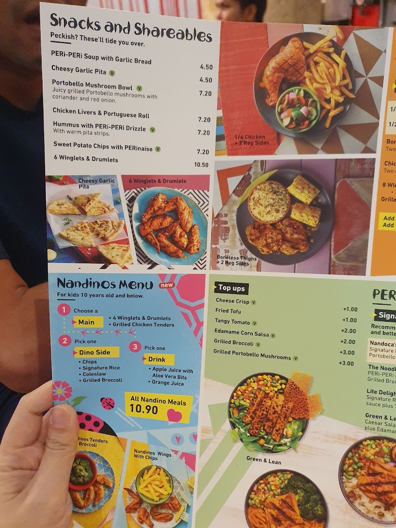 A close-up view of the Nandos menu, featuring snacks, shareables, and kids' meals.