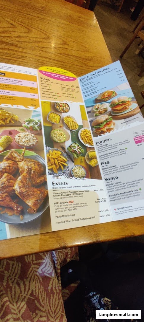 A detailed view of the Nando's menu, showcasing various chicken dishes, sides, burgers, and wraps.